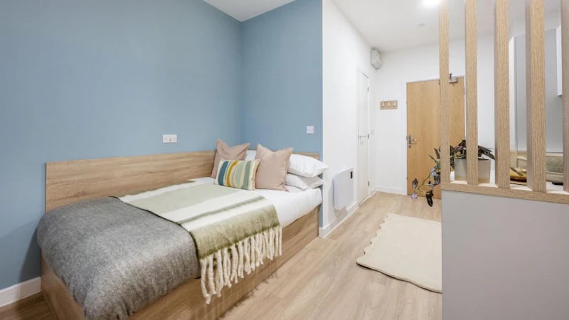 Bed pillows blanket and wooden headboard bedroom at St Gabriels in Manchester Student Accommodation