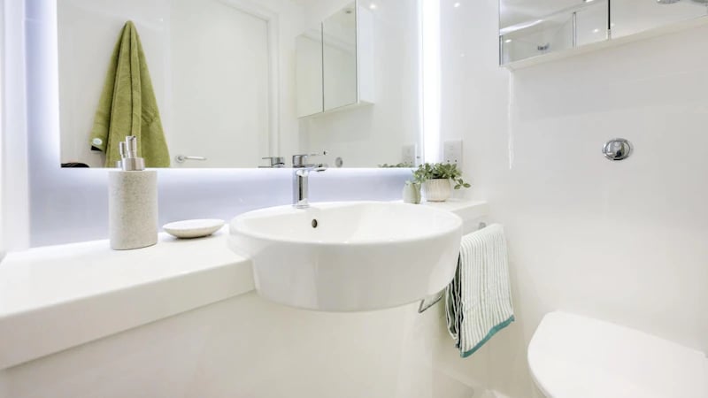 Sink soap dispenser towel and toilet bathroom at St Gabriels in Manchester Student Accommodation