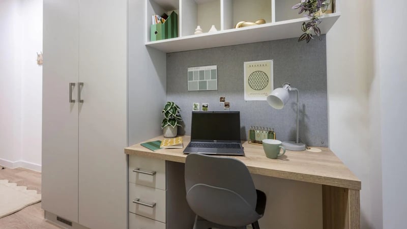 Desk with laptop plants calendar lamp chair Study area at St Gabriels in Manchester Student Accommodation