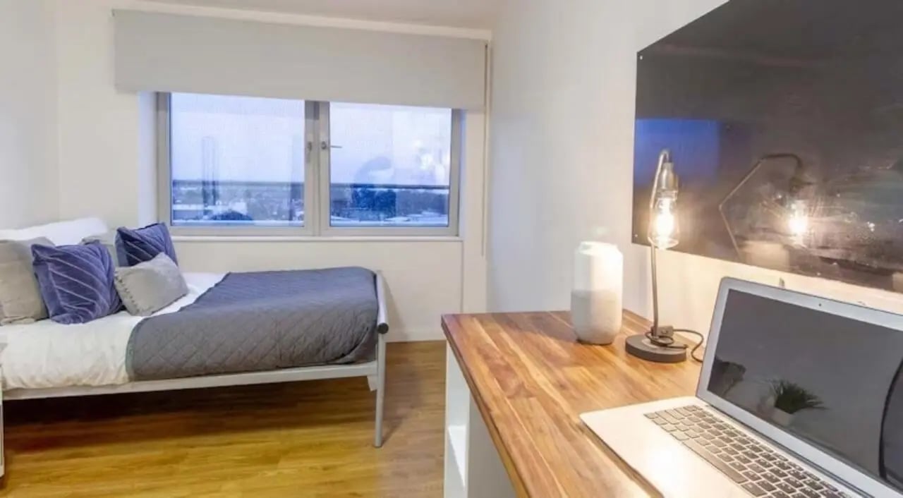 Bed desk with laptop and lamp bedroom at The Glasshouse in Nottingham Student Accommodation