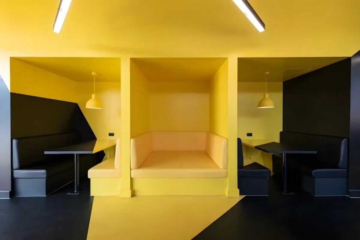 Yellow booths tables and lighting study area at Luxurio in Loughborough Student Accommodation