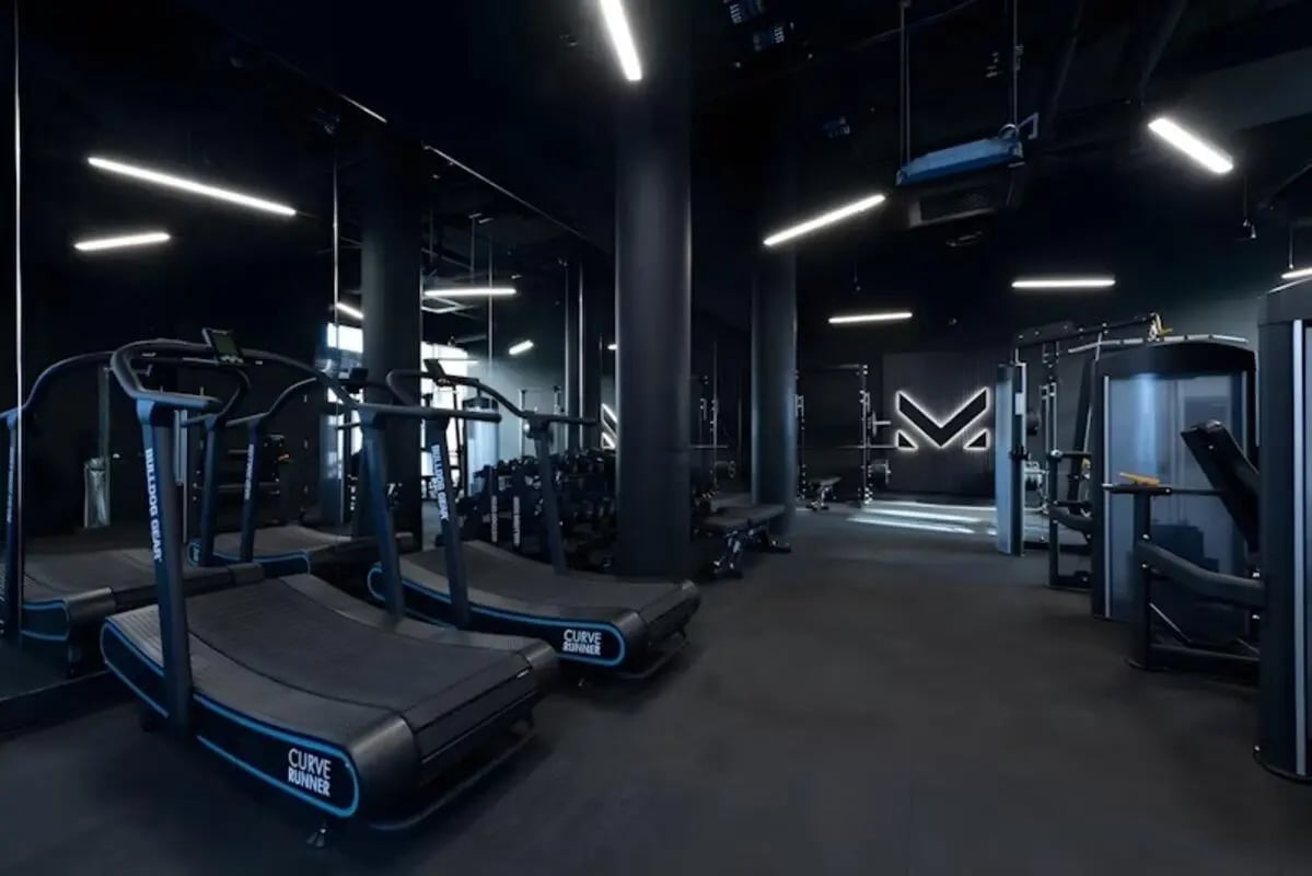 Two treadmills weight racks and gym equipment gym at Luxurio in Loughborough Student Accommodation
