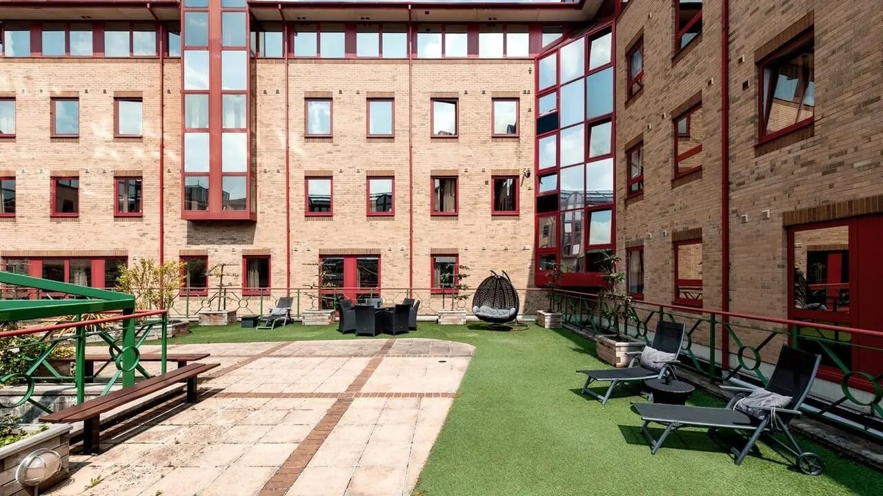 Patio furniture benches and chairs outdoor space exterior at Collegiate Castle Street in Cambridge Student Accommodation