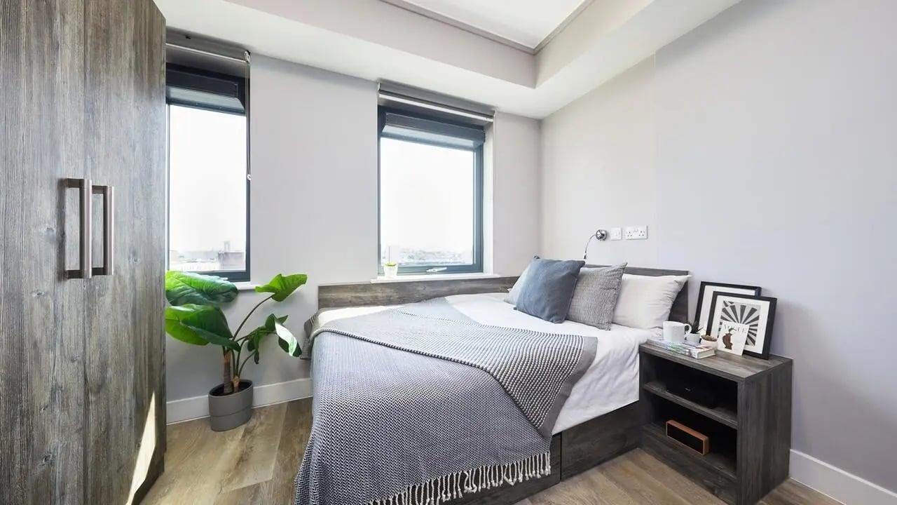 Bed with bedside table and wardrobe bedroom at Collegiate Crown Place Portsmouth in Portsmouth Student Accommodation