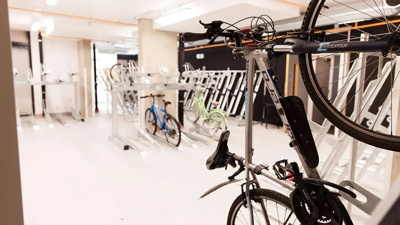 Bicycle racks with multiple bikes inside interior storage area at Collegiate Crown Place Portsmouth in Portsmouth Student Accommodation
