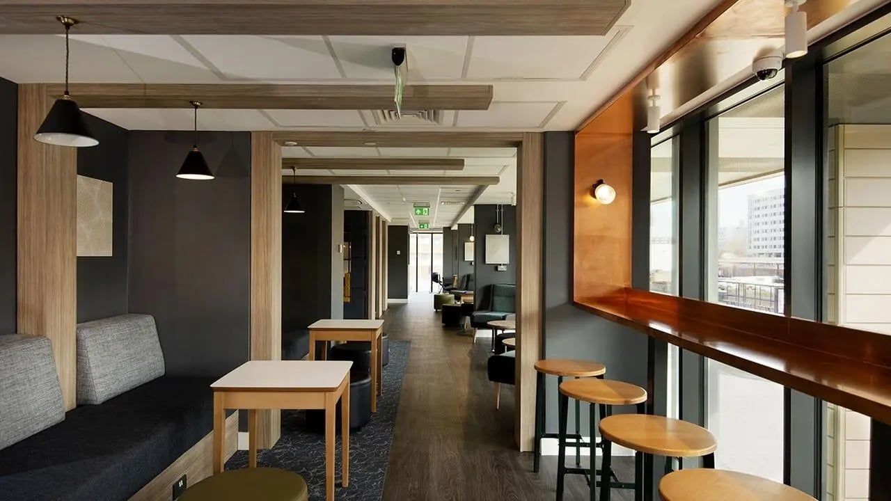Sofa tables and stools in shared lounge area at Collegiate Crown Place Portsmouth in Portsmouth Student Accommodation