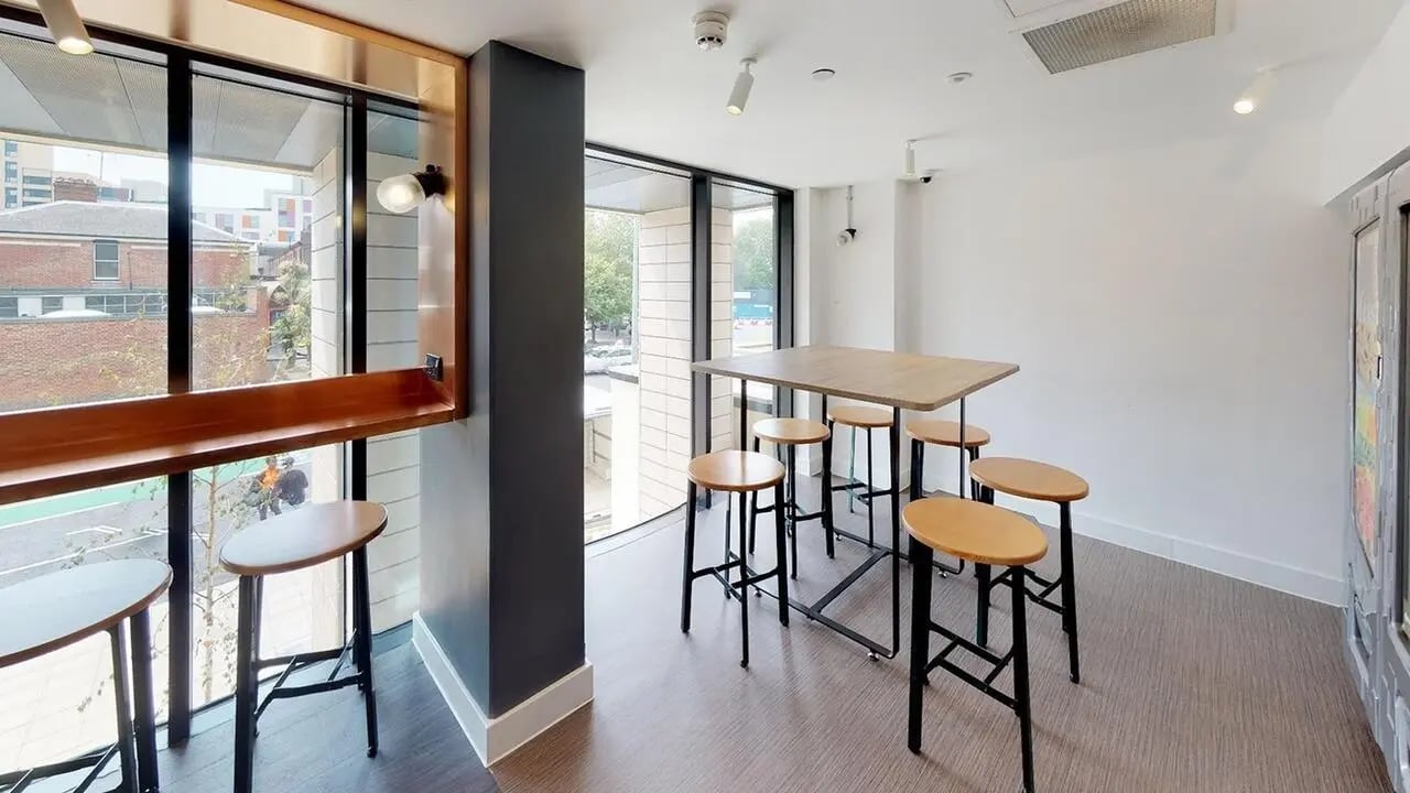 Bar stools and a table with stools communal area at Collegiate Crown Place Portsmouth in Portsmouth Student Accommodation