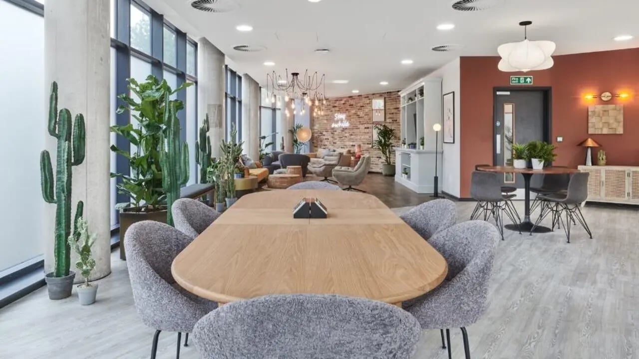 Large wooden table with grey chairs communal area living room at Gosford Gate in Coventry Student Accommodation