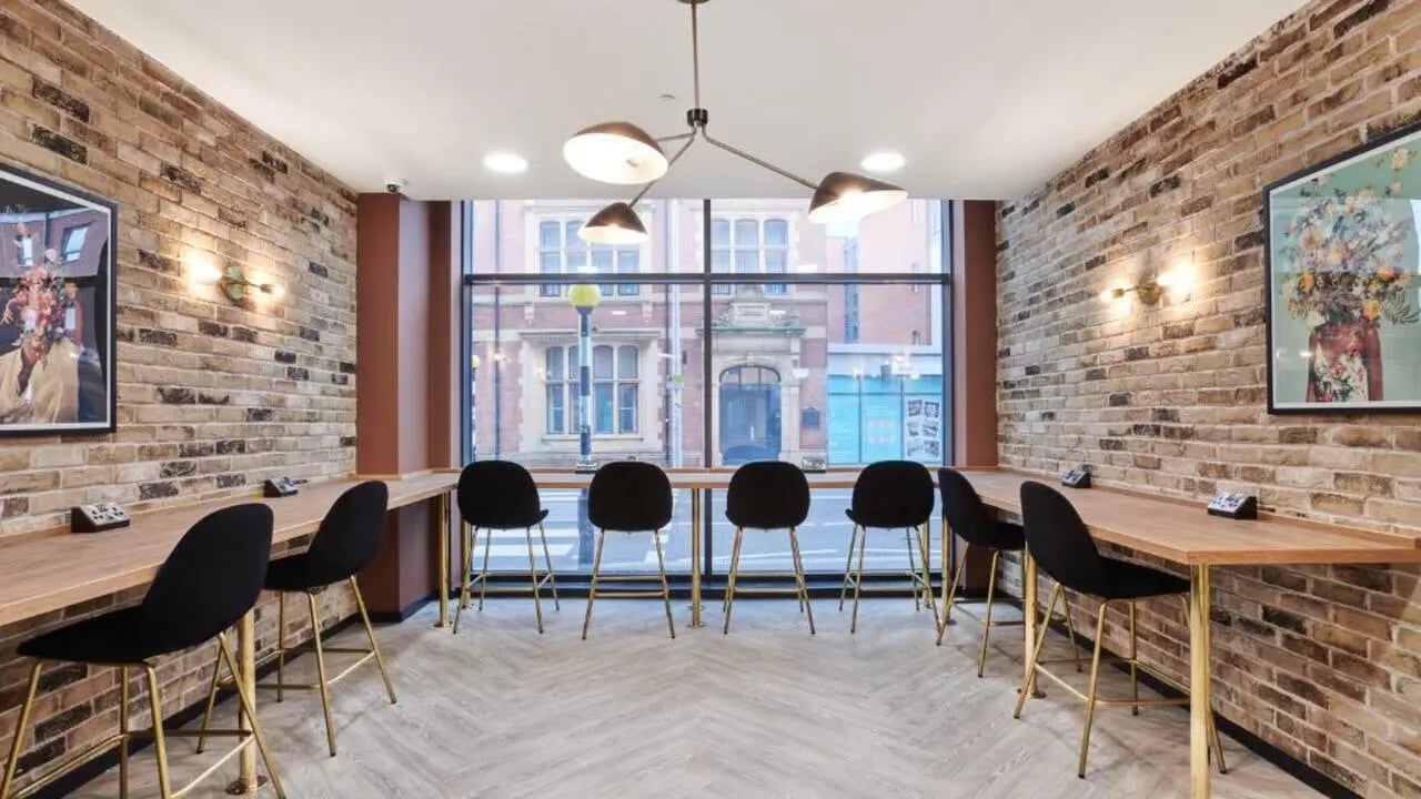 Wooden desks black stools artwork study area at Gosford Gate in Coventry Student Accommodation