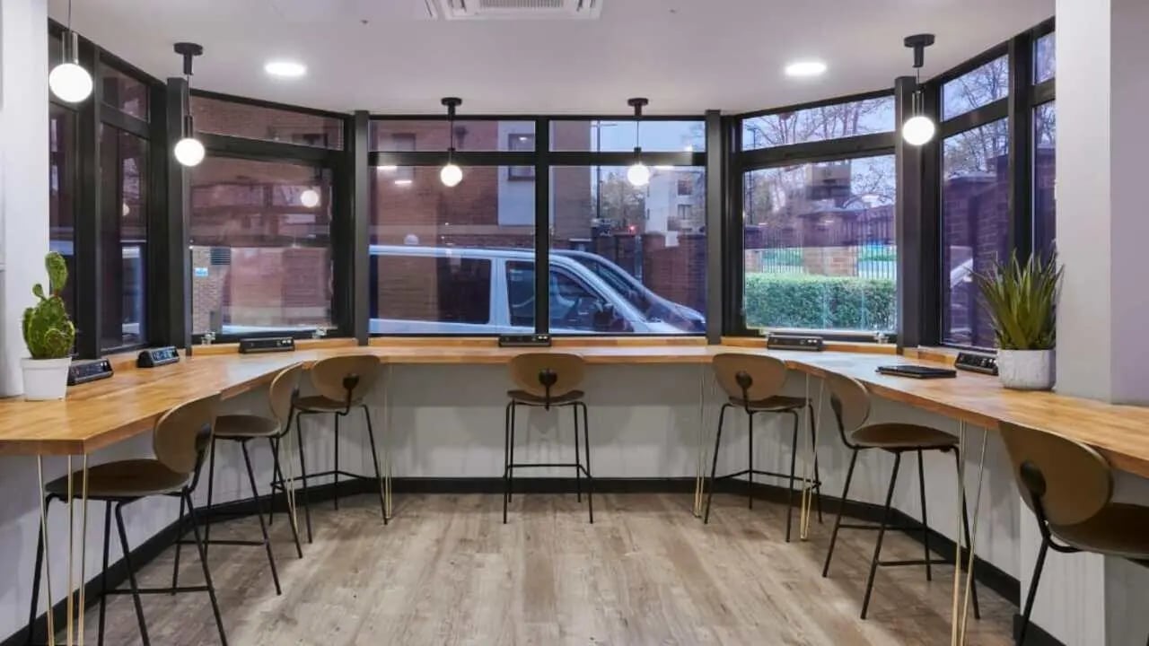 Wooden counter with bar stools study area at Sky Blue Point in Coventry Student Accommodation