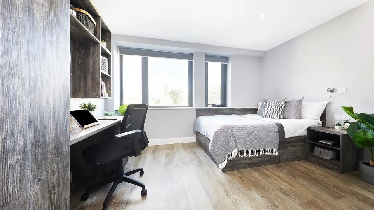 Desk bed nightstand plant and shelf bedroom at Collegiate Crown Place Cardiff in Cardiff Student Accommodation
