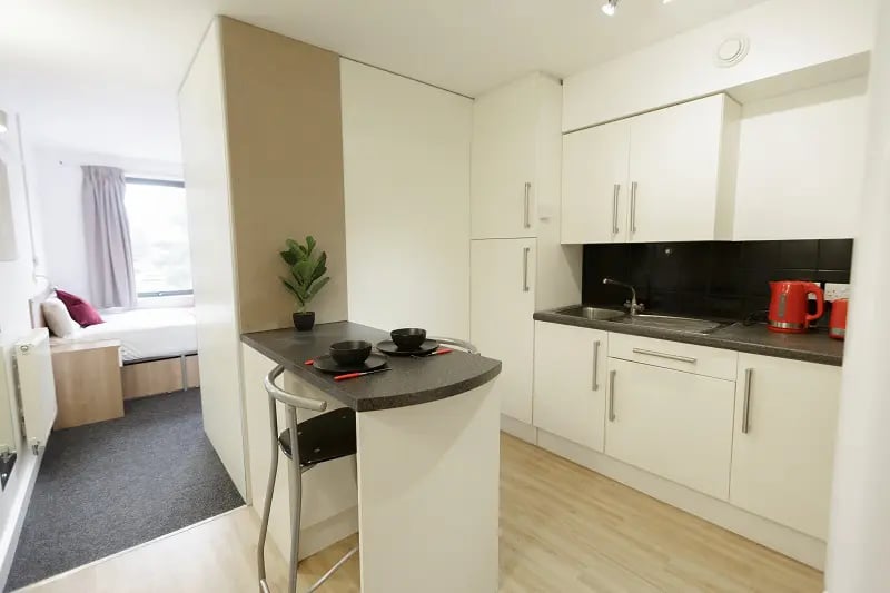 Kitchenette with small dining bar and bed area Kitchenette at AXO Camden in London Student Accommodation