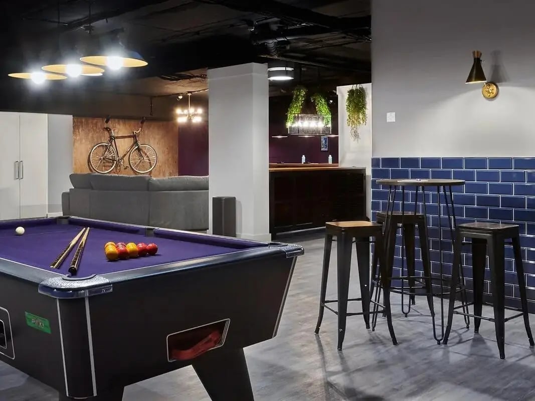 Pool table sofa bar stools and bike recreation area at CB1-Cambridge in Cambridge Student Accommodation