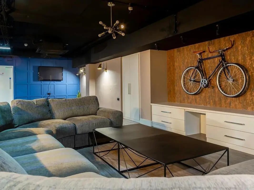 Stylish lounge with sofa and bike decor living room at CB1-Cambridge in Cambridge Student Accommodation