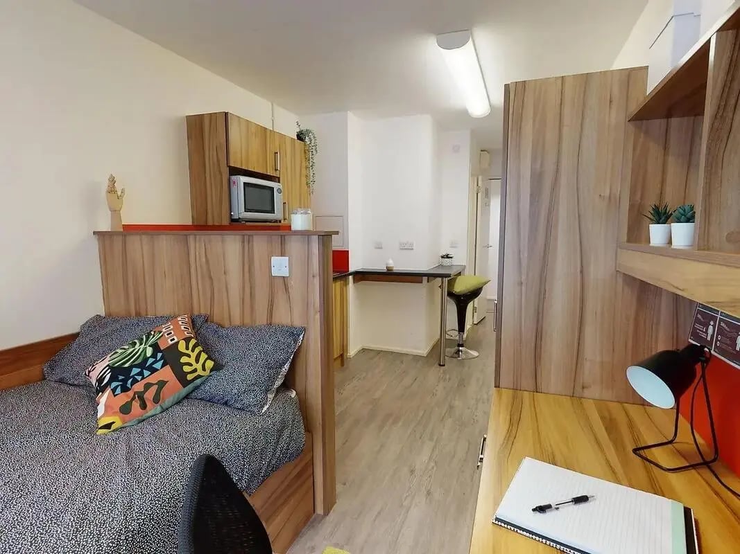 Bed microwave cabinets desk stool living room at CB1-Cambridge in Cambridge Student Accommodation