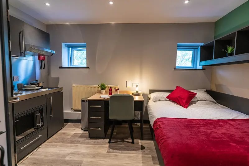 Bed desk and kitchenette student accommodation room at AXO Sherbourne Student Village in Coventry Student Accommodation