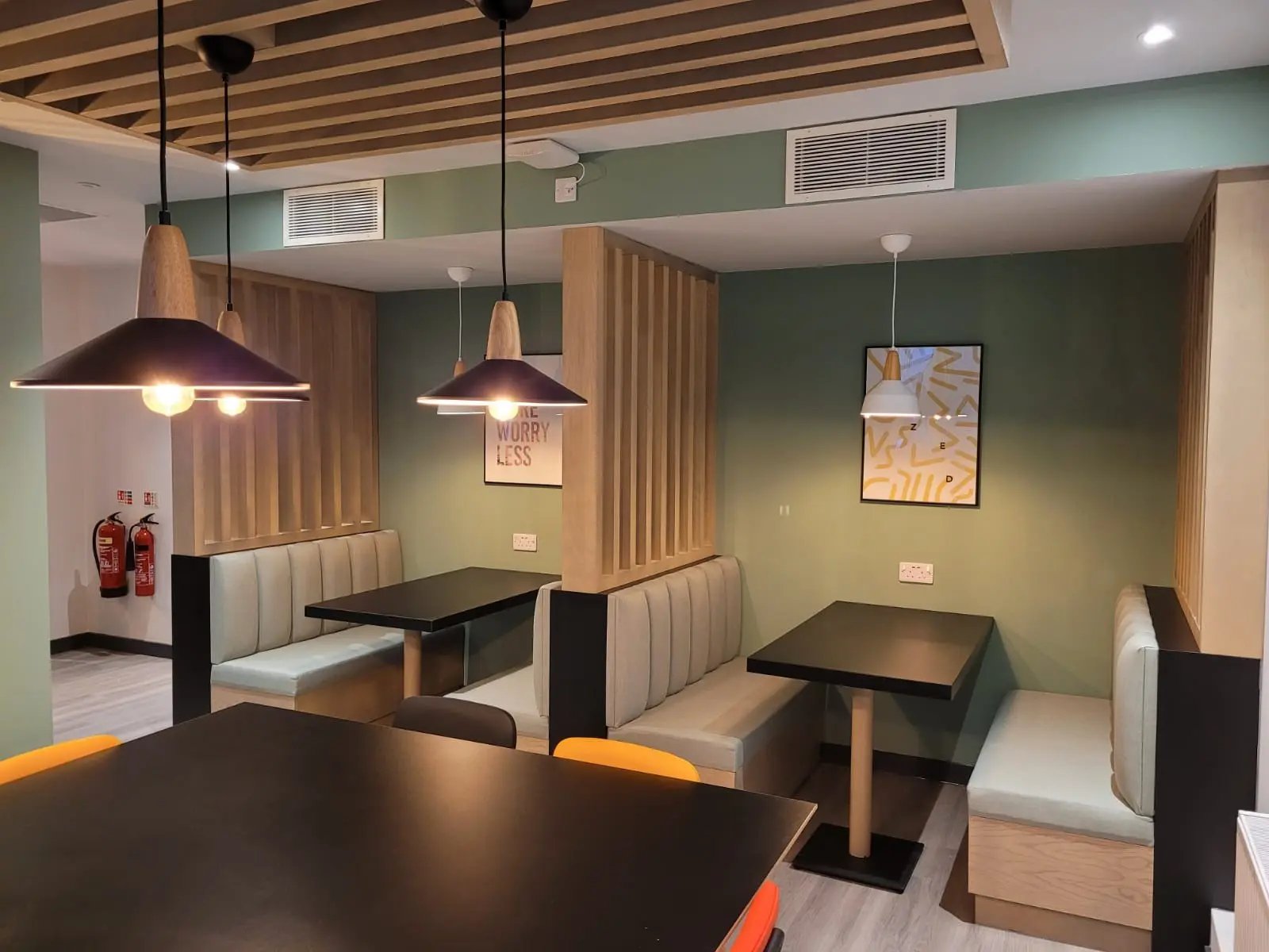 Booth seating tables and modern pendant lights communal area at AXO Sherbourne Student Village in Coventry Student Accommodation