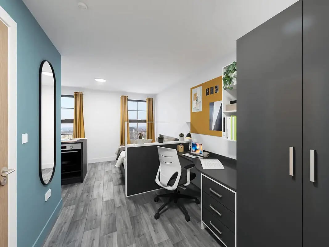 Desk mirror bed wardrobe and chair studio at Depot Point in London Student Accommodation