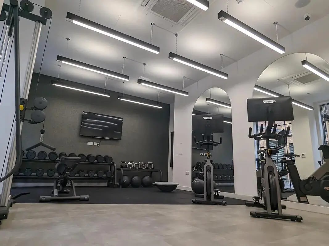 Gym with weight racks exercise bikes and television gym at Depot Point in London Student Accommodation