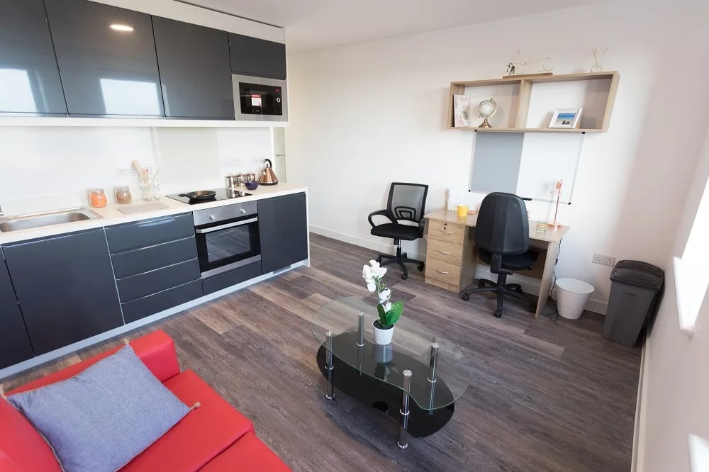 Modern studio kitchen desk and seating area. at City Heights - Cardiff in Cardiff Student Accommodation