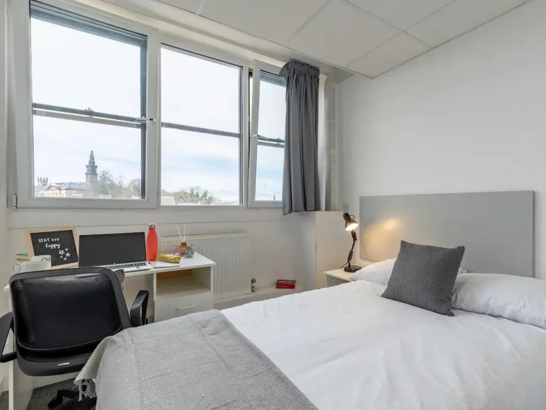 Desk laptop water bottle bed bedroom study area at Glasgow West-End in Glasgow Student Accommodation