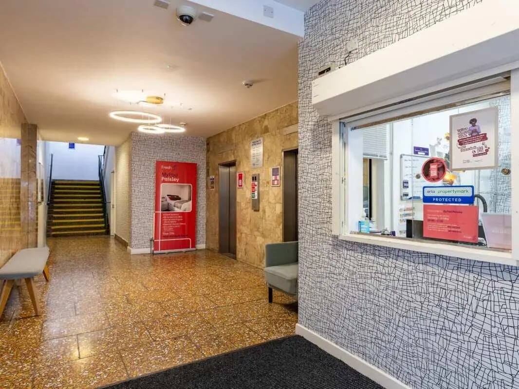 Lobby with stairs bench and reception counter Lobby at Glasgow West-End in Glasgow Student Accommodation