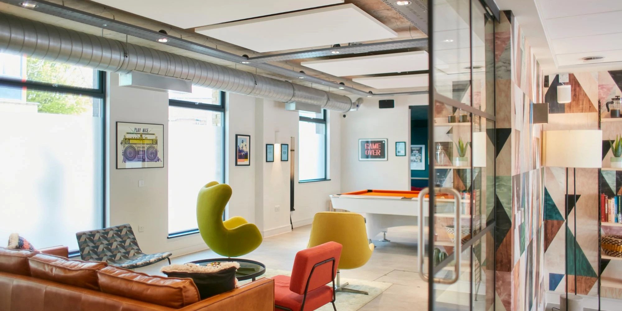 Leather sofa pool table chairs modern lounge area at Canvas Student - Quintana Gate in Exeter Student Accommodation