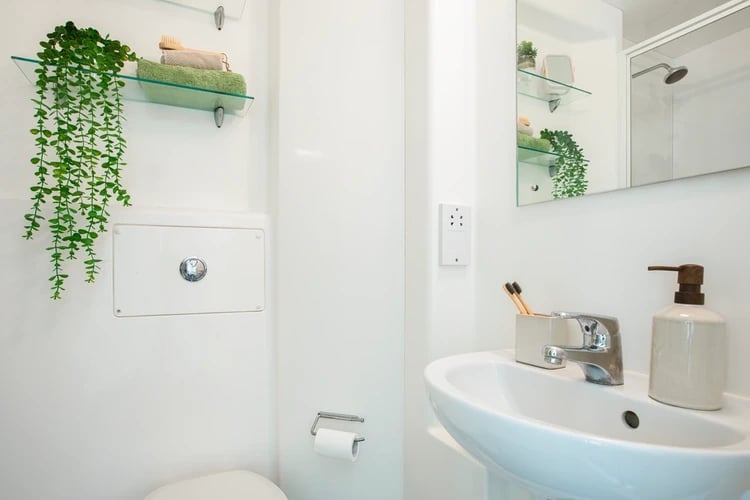 Sink toothbrush holder soap dispenser toilet roll bathroom at Moonraker Point in London Student Accommodation