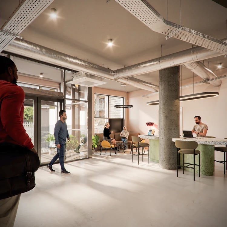 People in lounge area with seating and desks communal area at Burnet Point in Edinburgh Student Accommodation