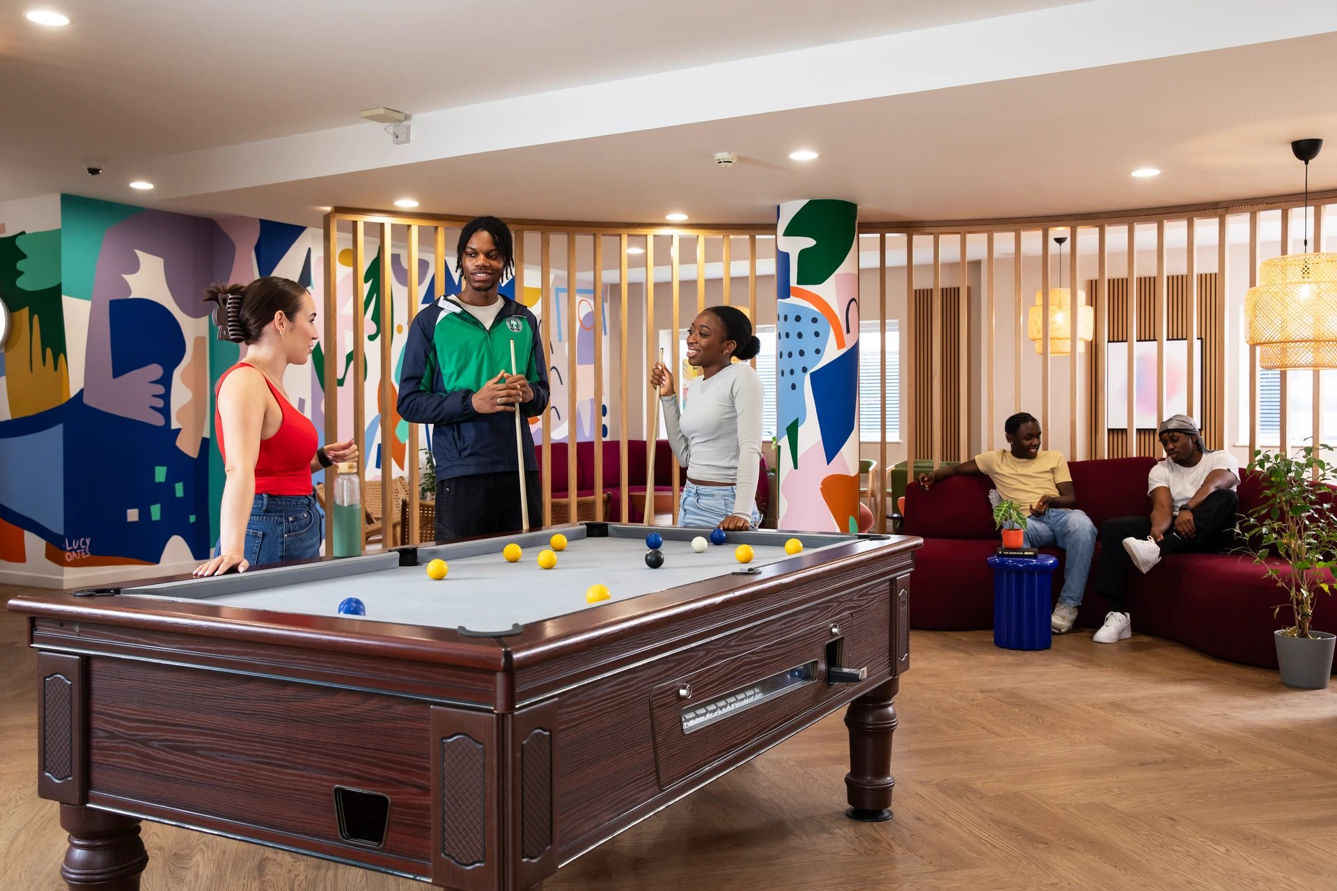 Pool table students playing billiards lounge area at Pier Quays in Medway Student Accommodation