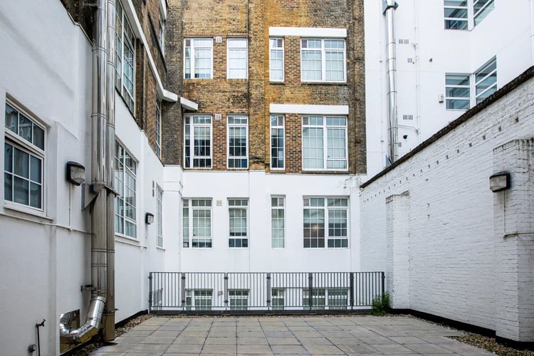 Paved courtyard with brick building exterior exterior at Walmsley Studios in London Student Accommodation