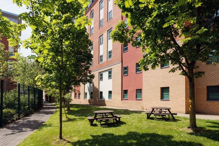 Picnic tables on lawn building exterior at Quay Point in Newcastle Upon Tyne Student Accommodation