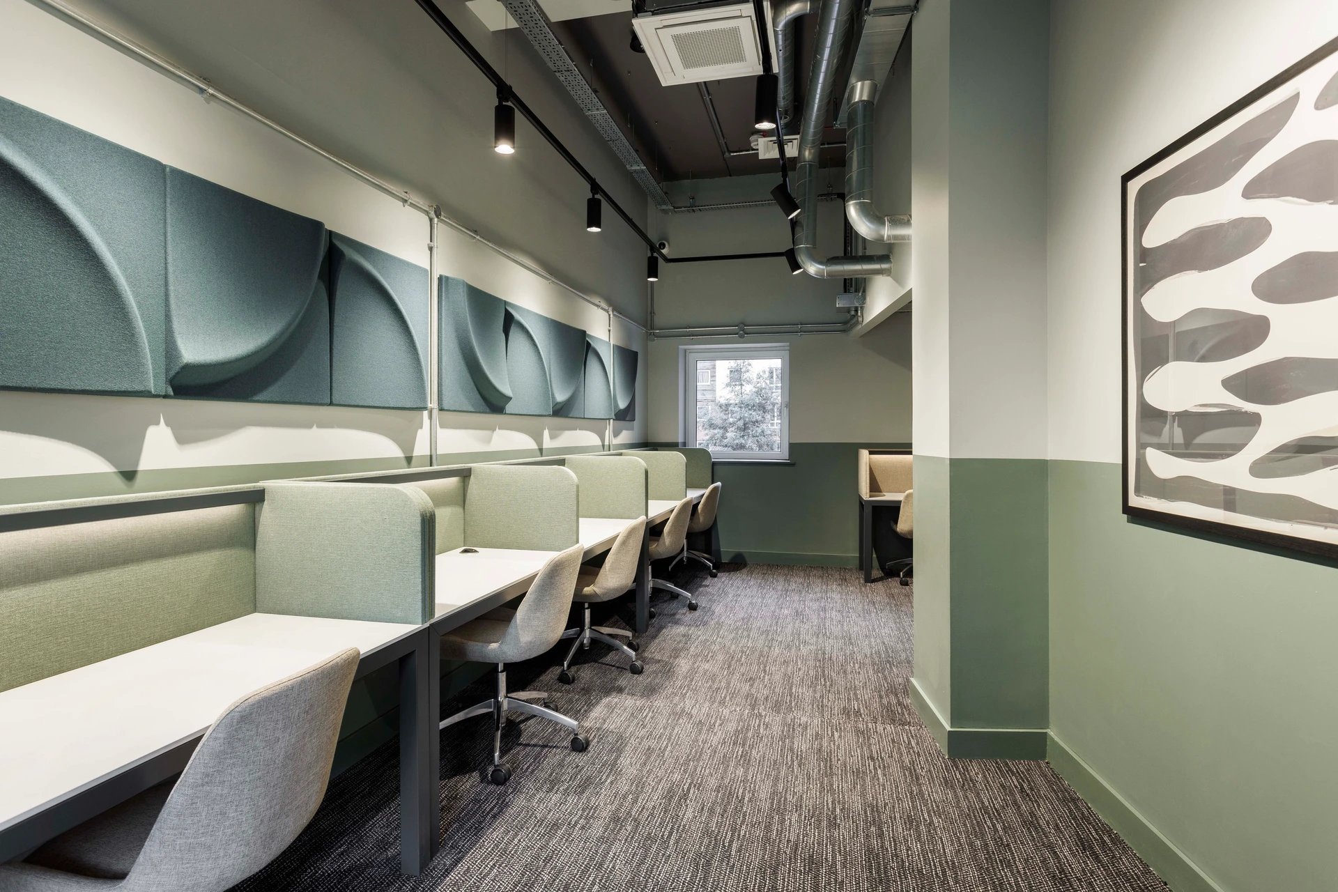 Study desks with chairs sound-absorbing panels interior at Cambrian Point in Cardiff Student Accommodation