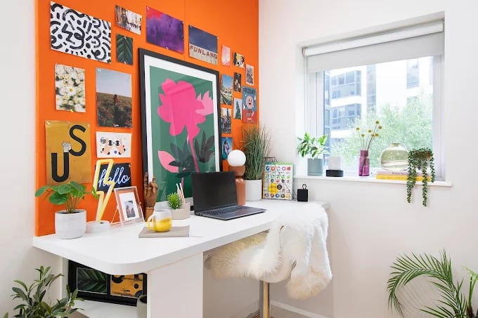 Desk with laptop plants artwork and chair study area at Adam Street Gardens in Cardiff Student Accommodation