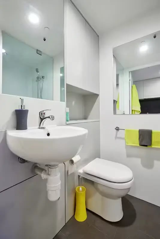 Sink toilet soap dispenser and towels bathroom at Scape Berkeley in Melbourne Student Accommodation