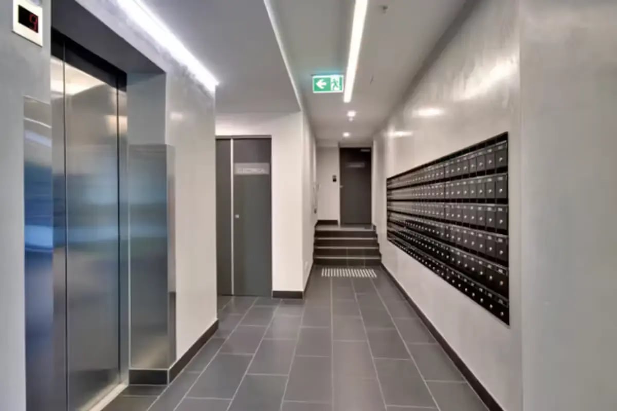 Hallway with elevator mailboxes and stairwell hallway at Scape Berkeley in Melbourne Student Accommodation