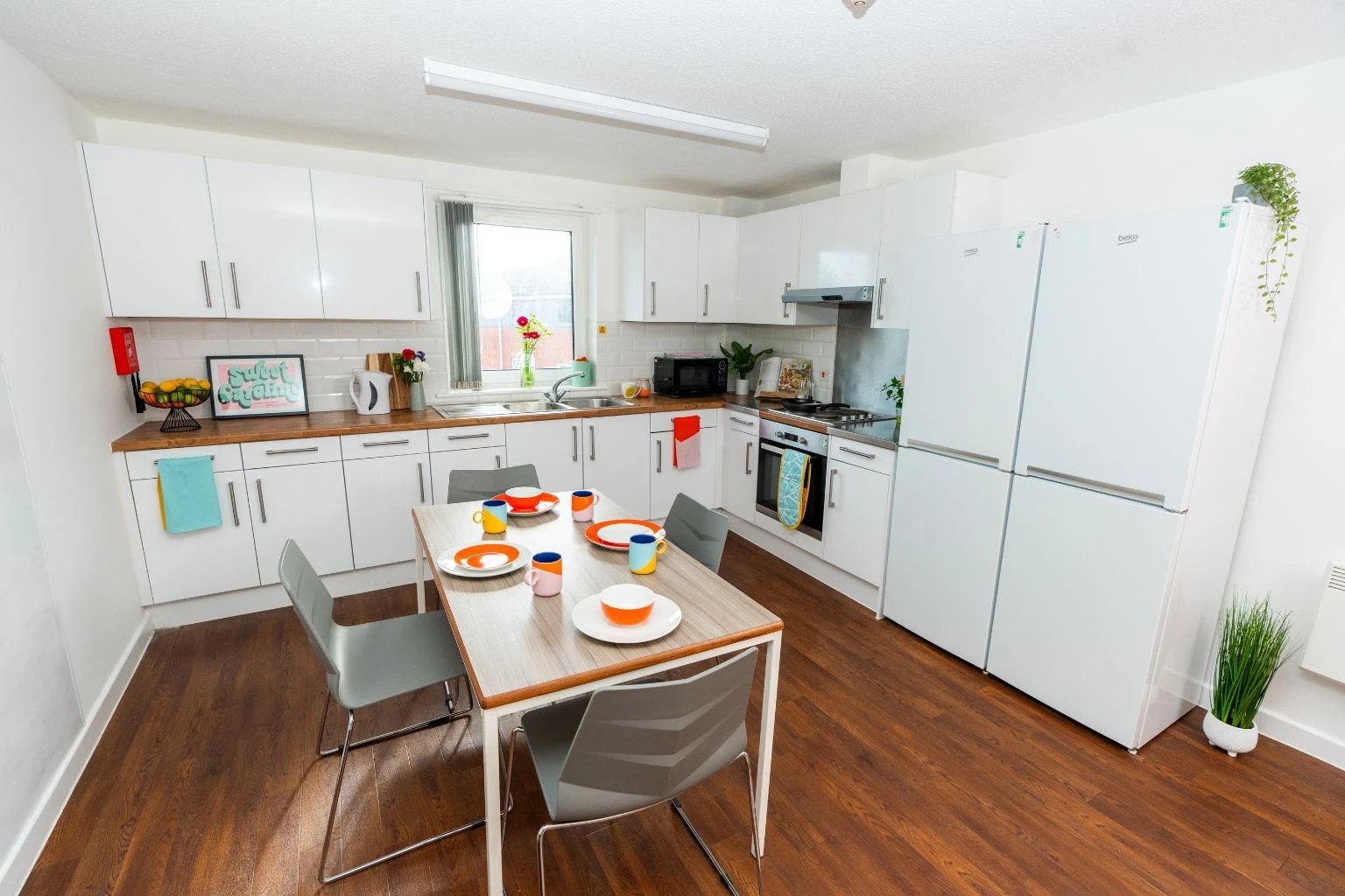 Kitchen with dining table and chairs kitchenware kitchen at Tramways - Salford in Salford Student Accommodation
