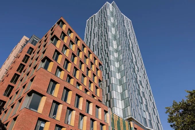 Brick and glass buildings under blue sky exterior at Scape Leeds in Leeds Student Accommodation