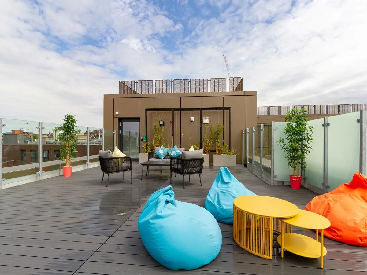 Bean bags and tables on outdoor terrace area at The Refinery in Leeds Student Accommodation