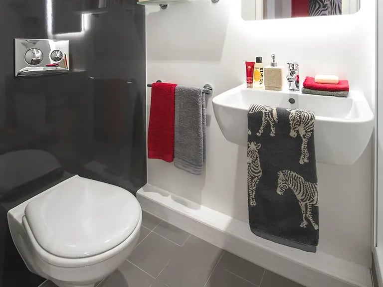 Toilet sink with towels and toiletries bathroom at Yugo Arran House in Edinburgh Student Accommodation