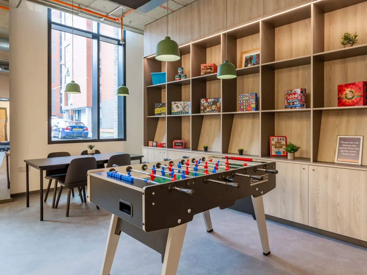 Foosball table shelves with games dining area living room at The Tannery Leicester in Leicester Student Accommodation