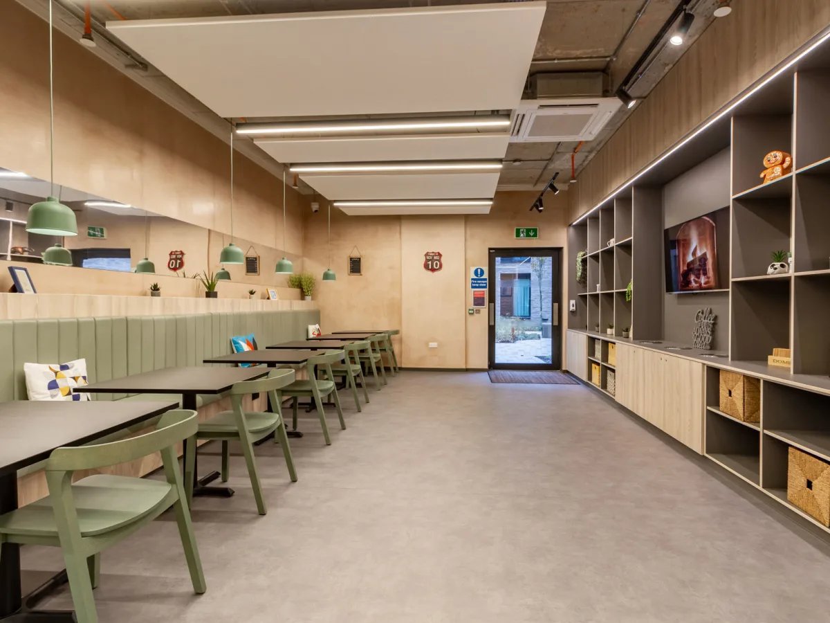 Tables chairs and shelves communal area at The Tannery Leicester in Leicester Student Accommodation