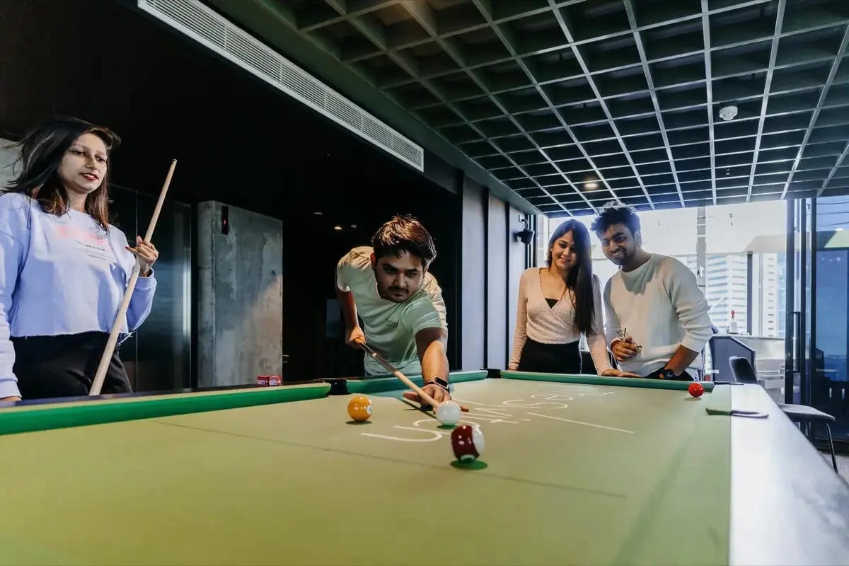 Students play pool on green table gaming area at Perth Central in Perth Student Accommodation