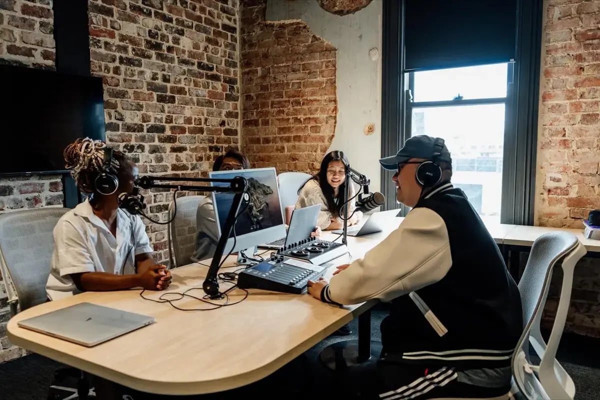 People podcasting at desk with computers and microphones lounge at Perth Central in Perth Student Accommodation