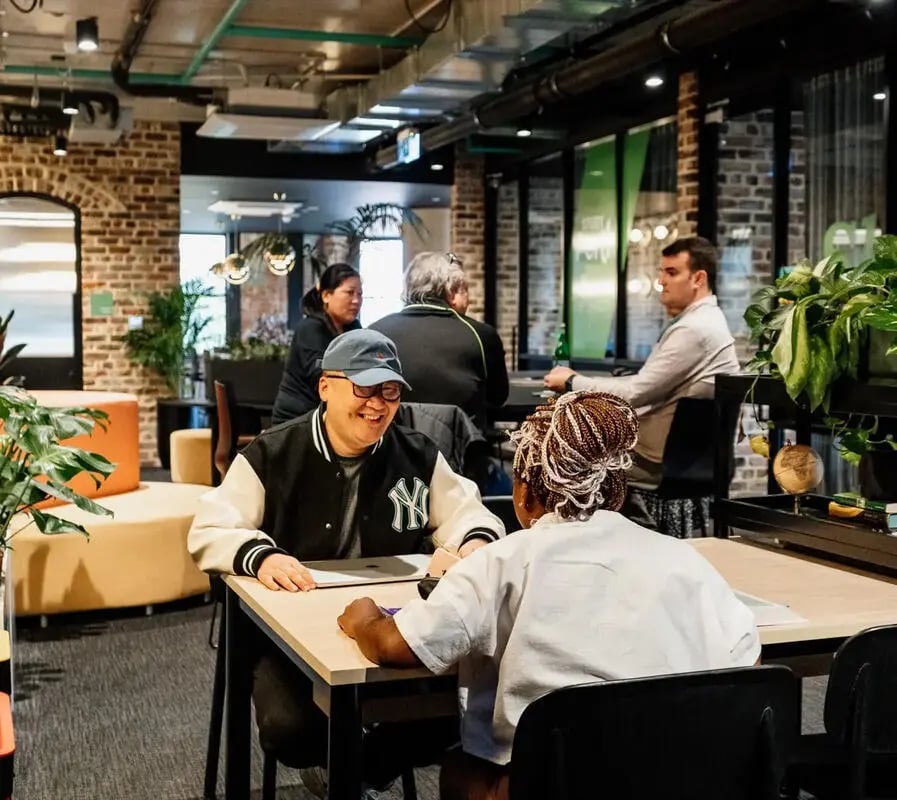 Students interacting at communal tables common area at Perth Central in Perth Student Accommodation