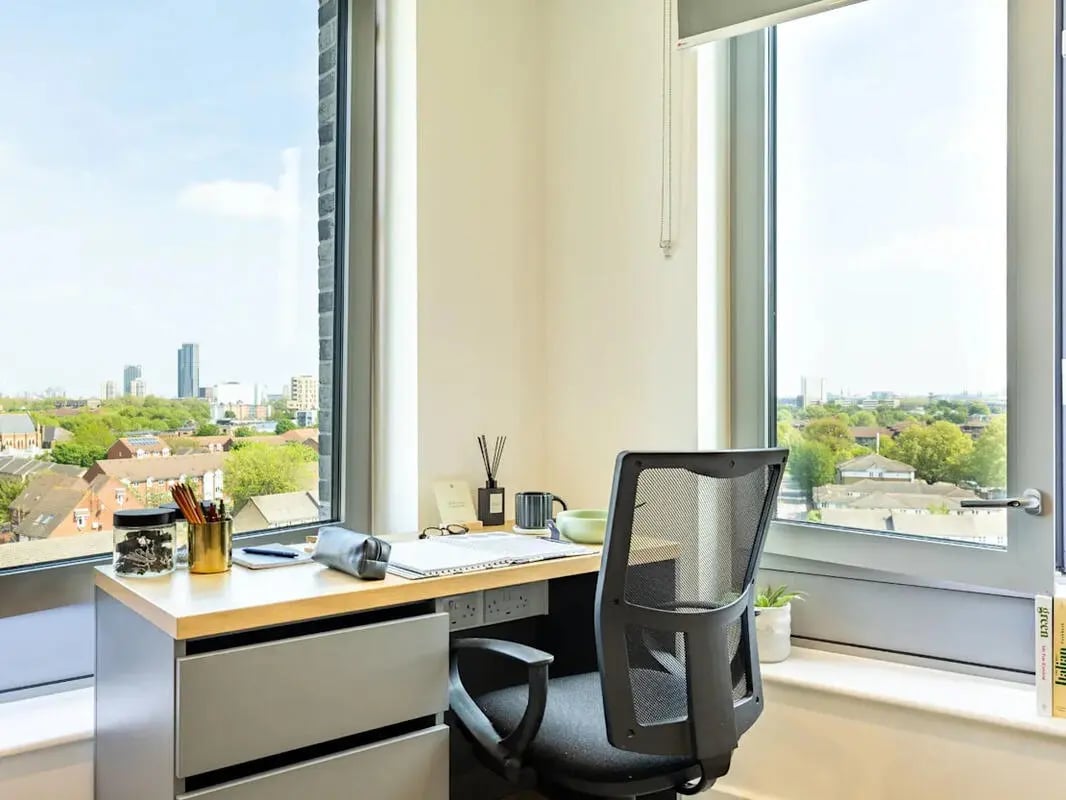 Desk with chair and cityscape view Study Area at Great Court in London Student Accommodation