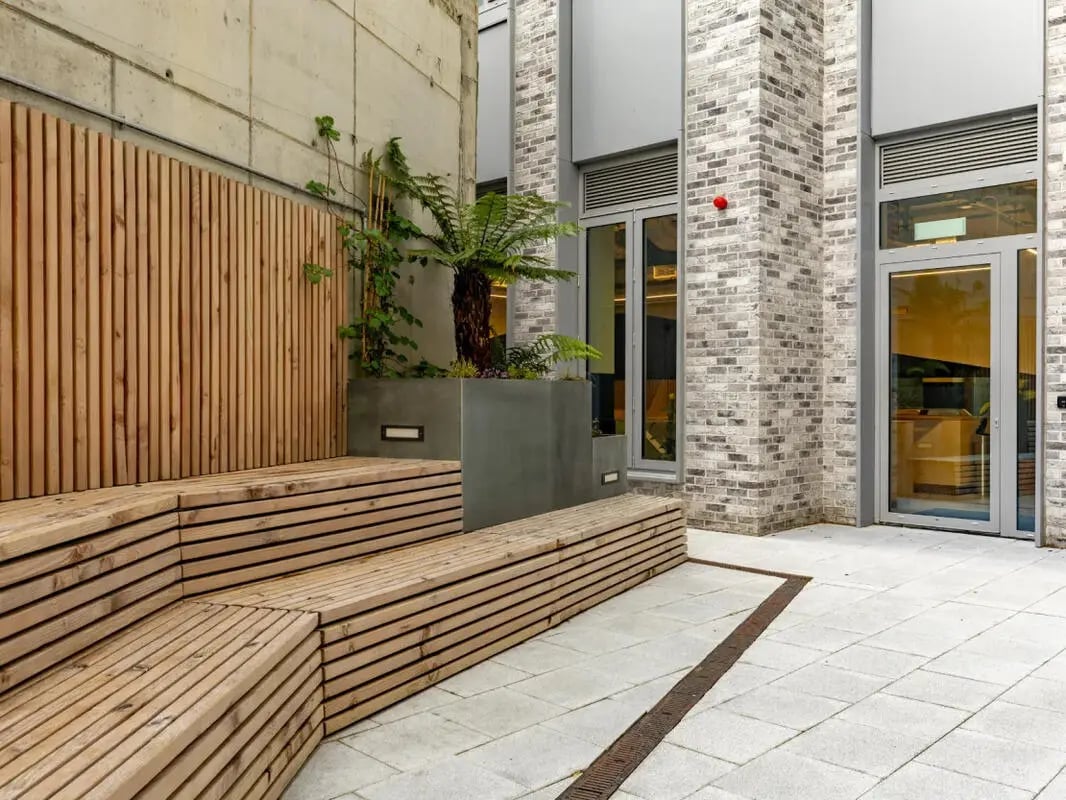 Wooden tiered seating with plants exterior at Great Court in London Student Accommodation