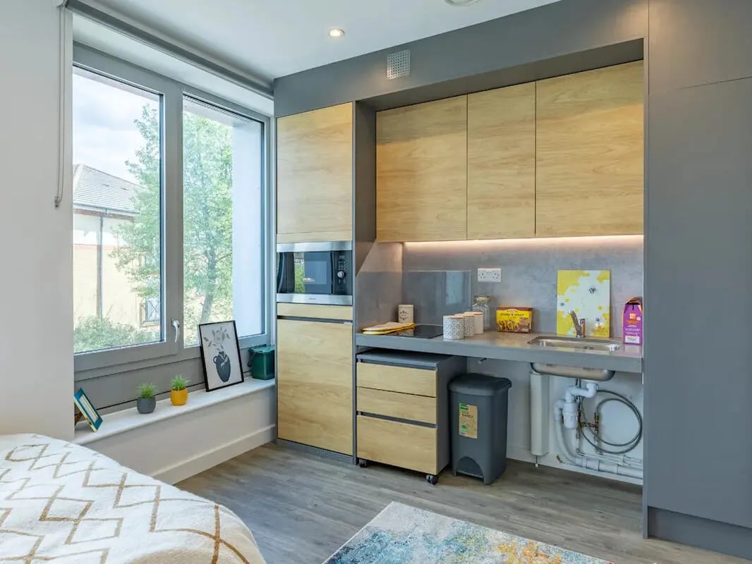Modern studio kitchenette with microwave sink and cabinets kitchen at Great Court in London Student Accommodation