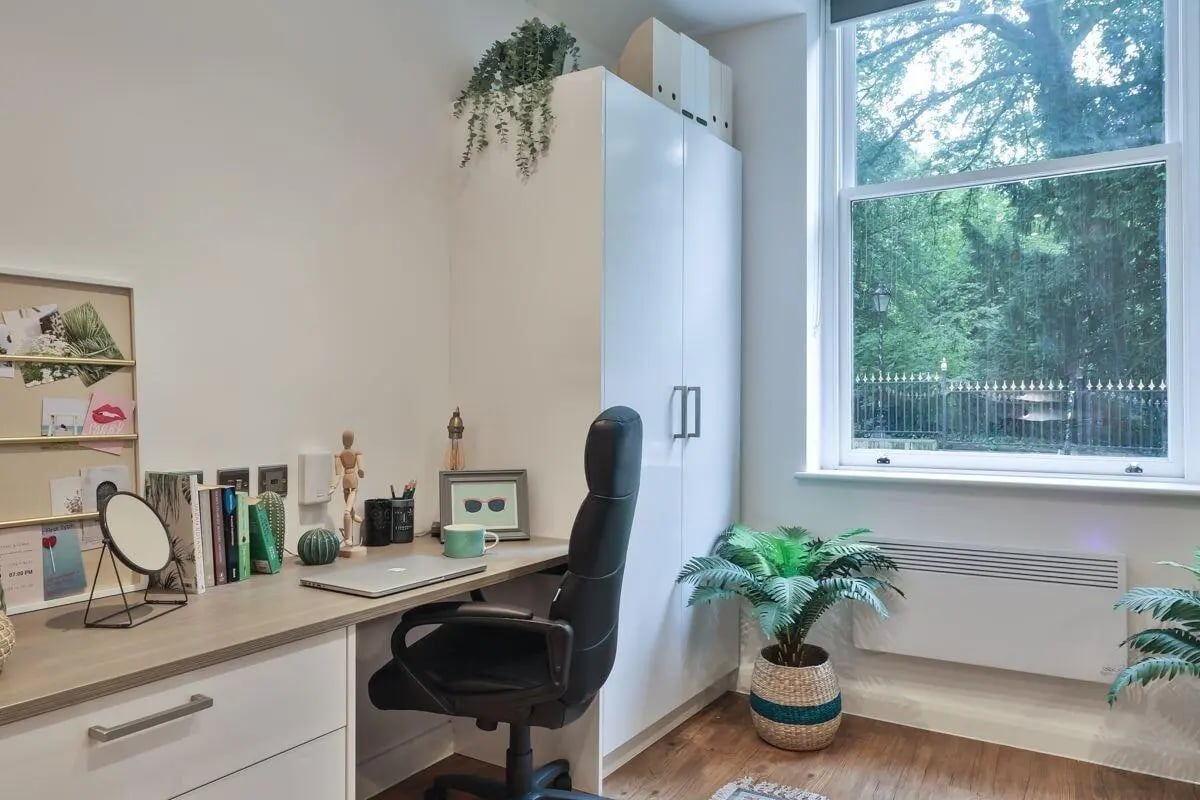 Desk chair laptop and plants study area at 140 New Walk Leicester in Leicester Student Accommodation
