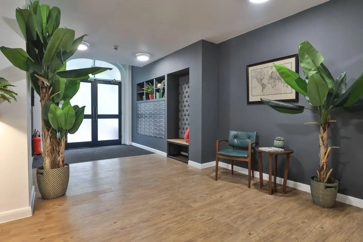 Plants mailboxes chair map and table entrance area at 140 New Walk Leicester in Leicester Student Accommodation